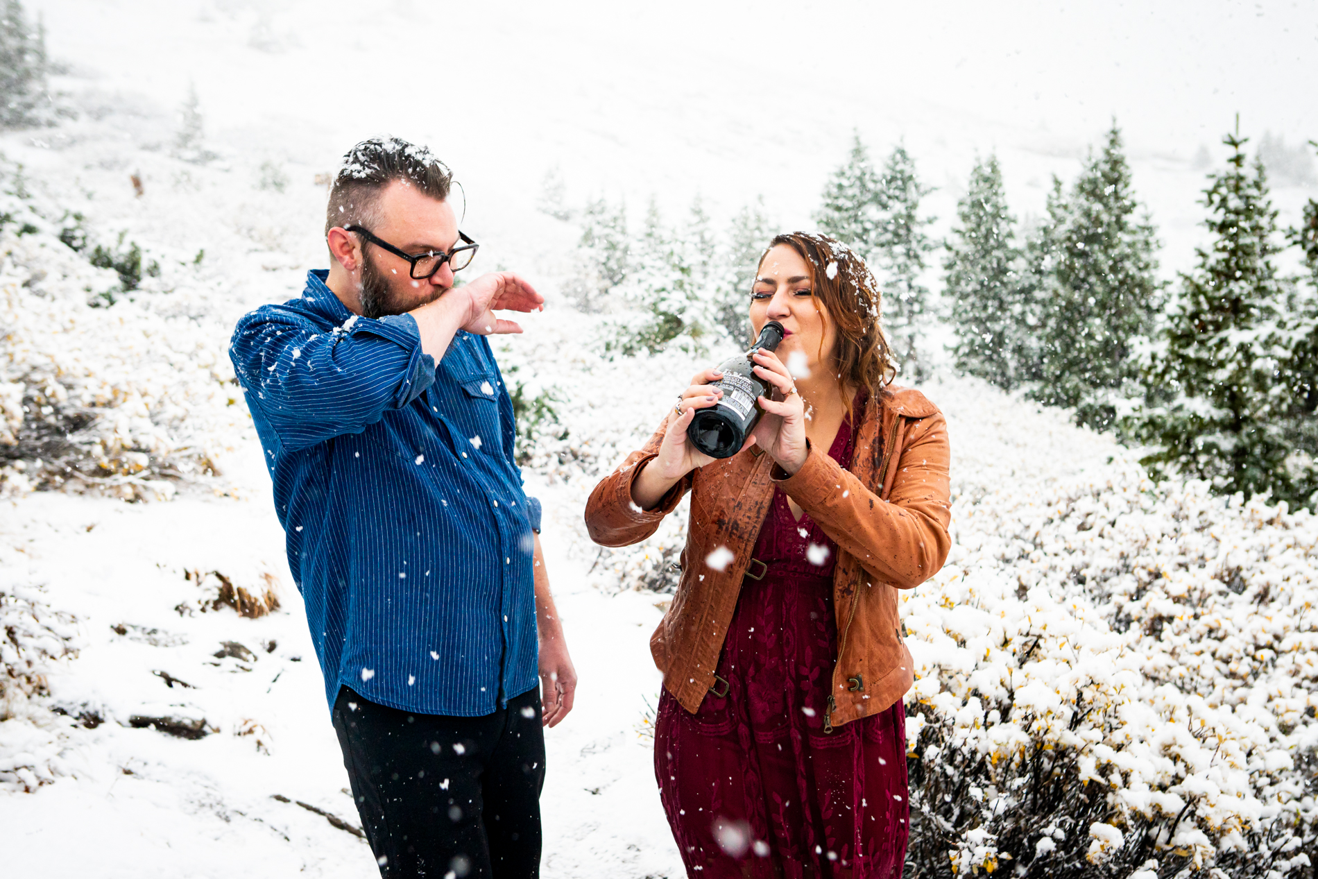 Cottonwood Pass Engagement Photos in Buena Vista with fall foliage, mountains and a winter blizzard