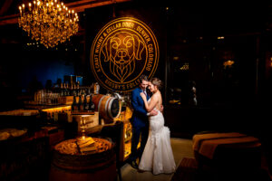 Bride and groom portrait at Bigsby's Folly Craft Winery in Denver with the dog mural in the background