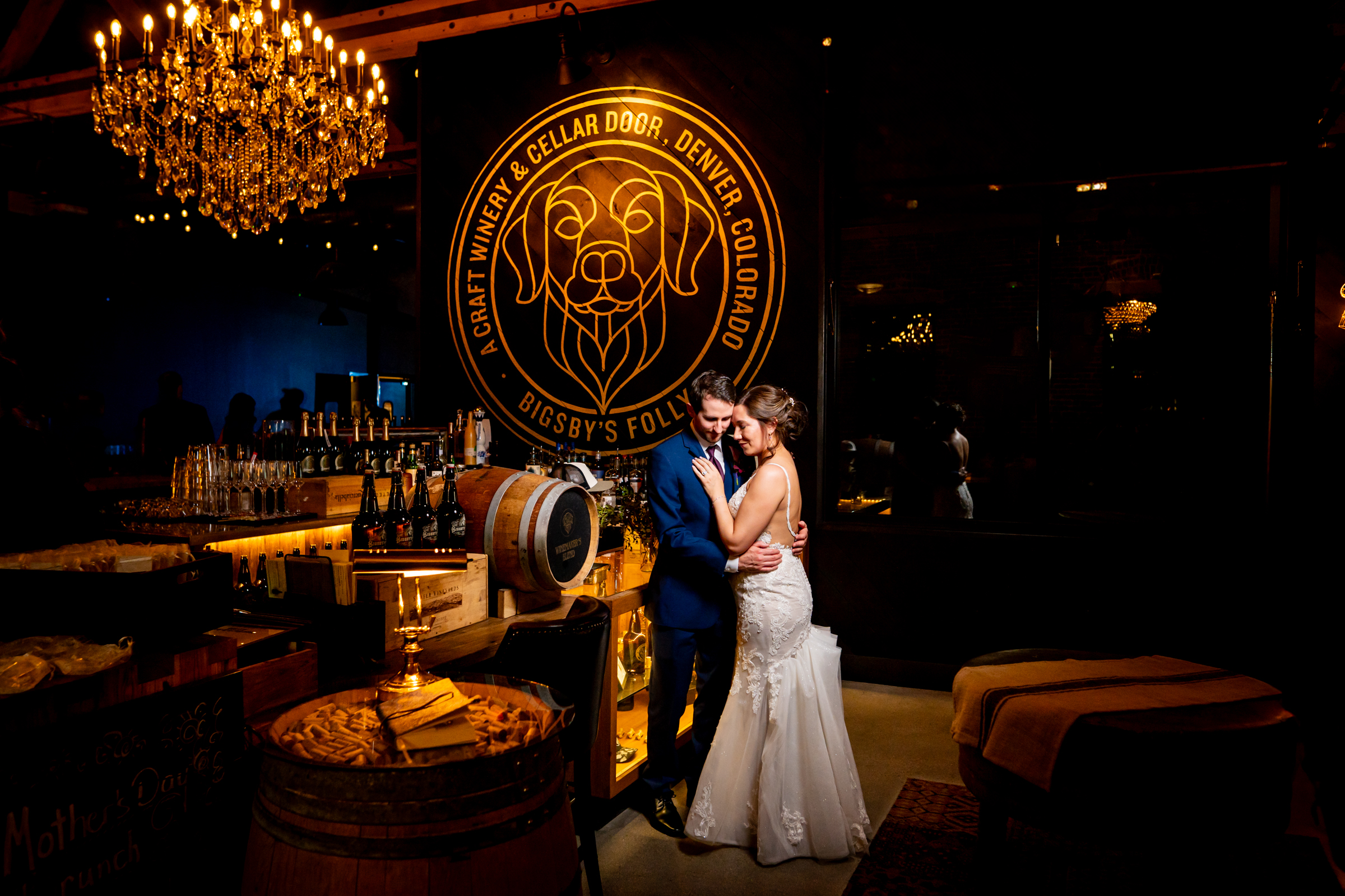 Bride and groom portrait at Bigsby's Folly Craft Winery in Denver with the dog mural in the background