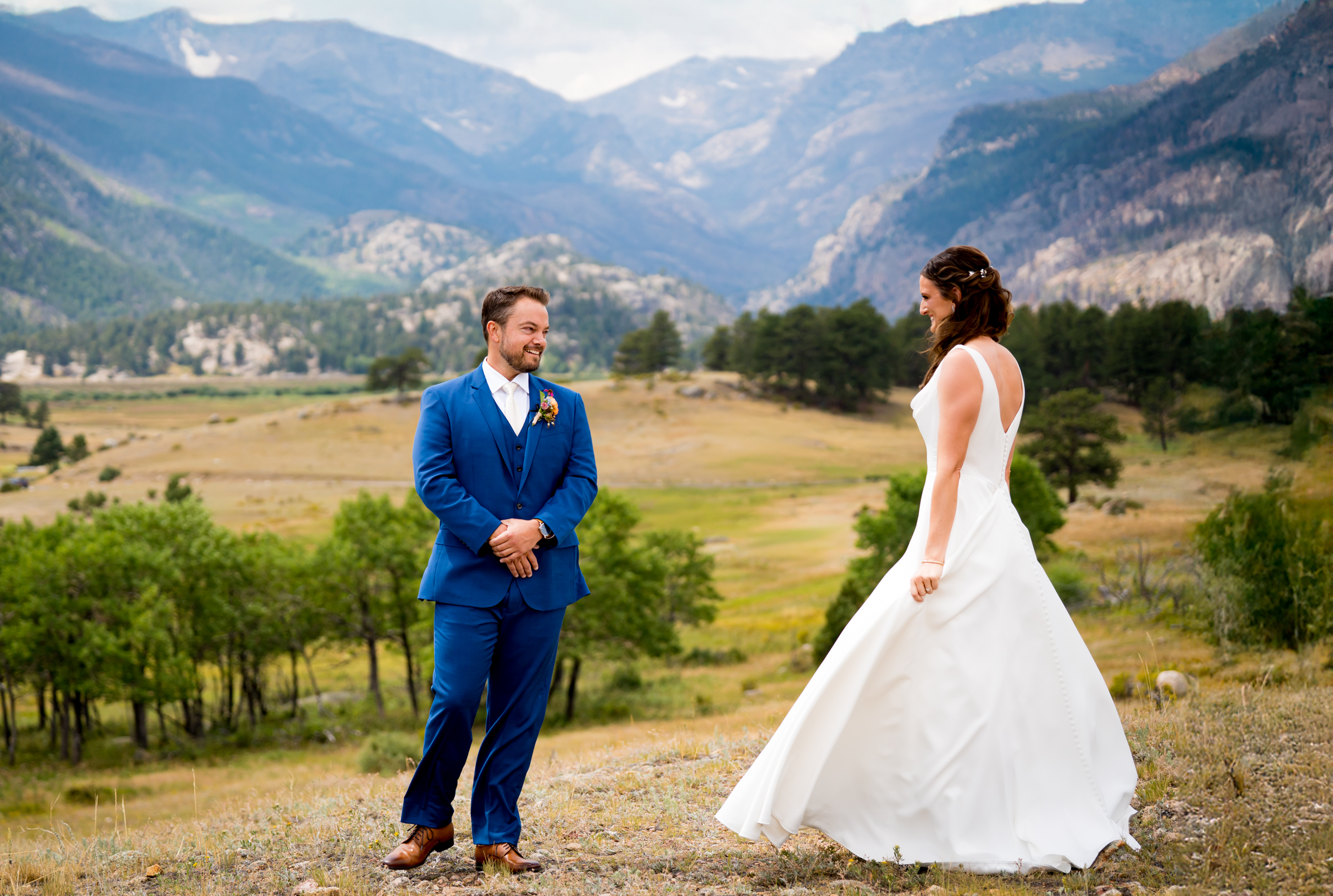 Bride and grooms share first look at Rocky Mountain National Park with the mountains and meadows in the distance