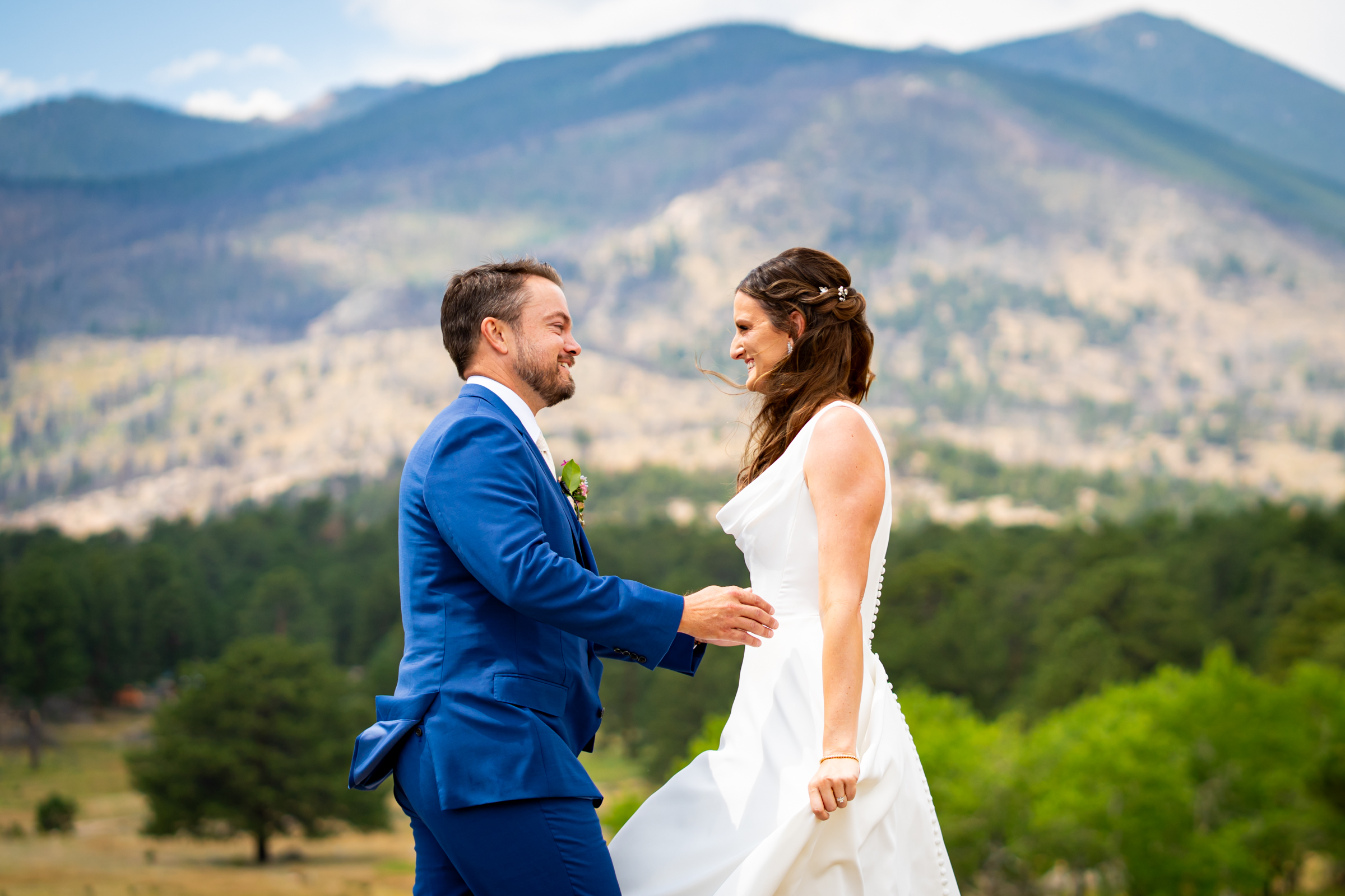 Bride and grooms share first look at Rocky Mountain National Park with the mountains and meadows in the distance