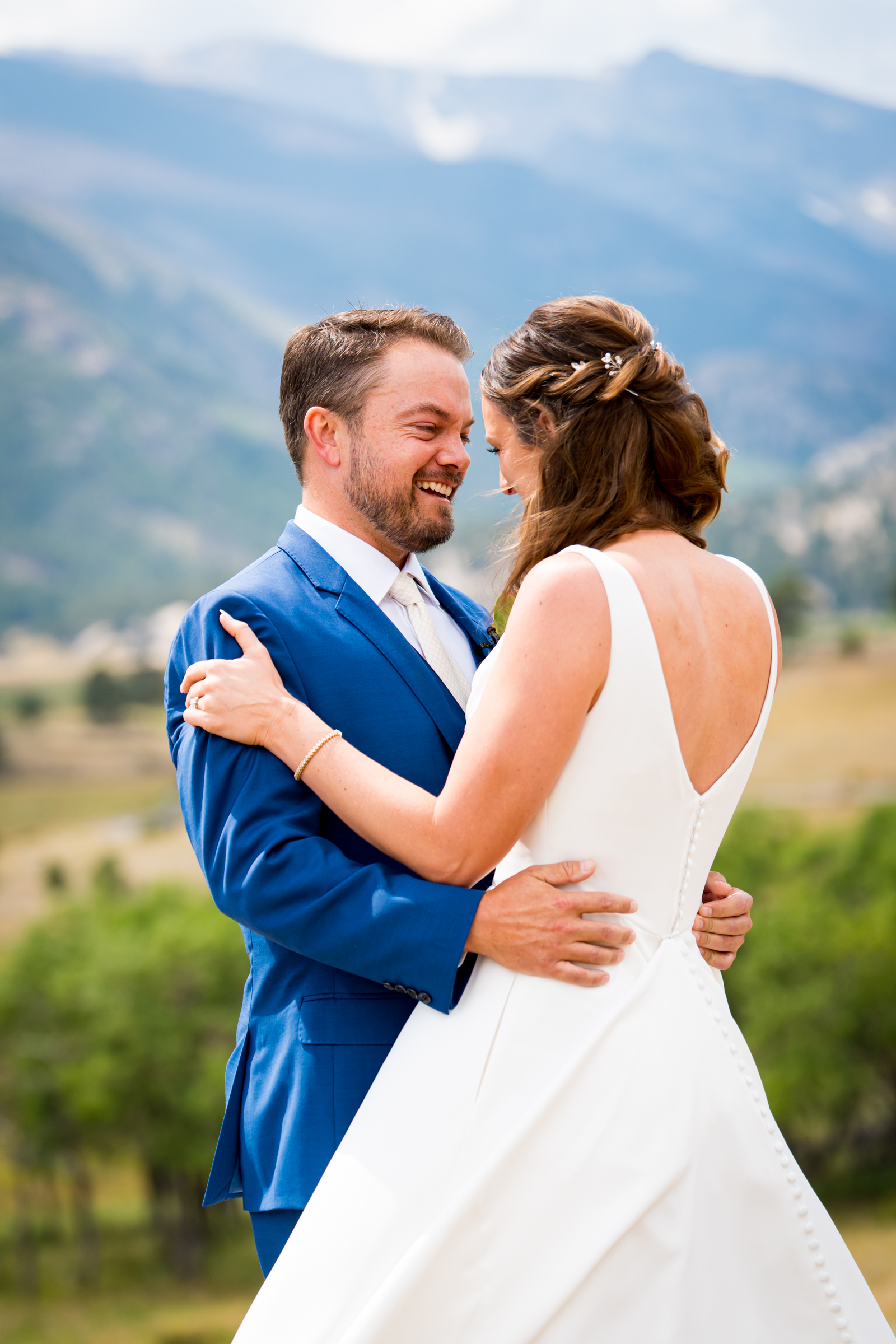 Bride and grooms share first look at Rocky Mountain National Park with the mountains and meadows in the distance