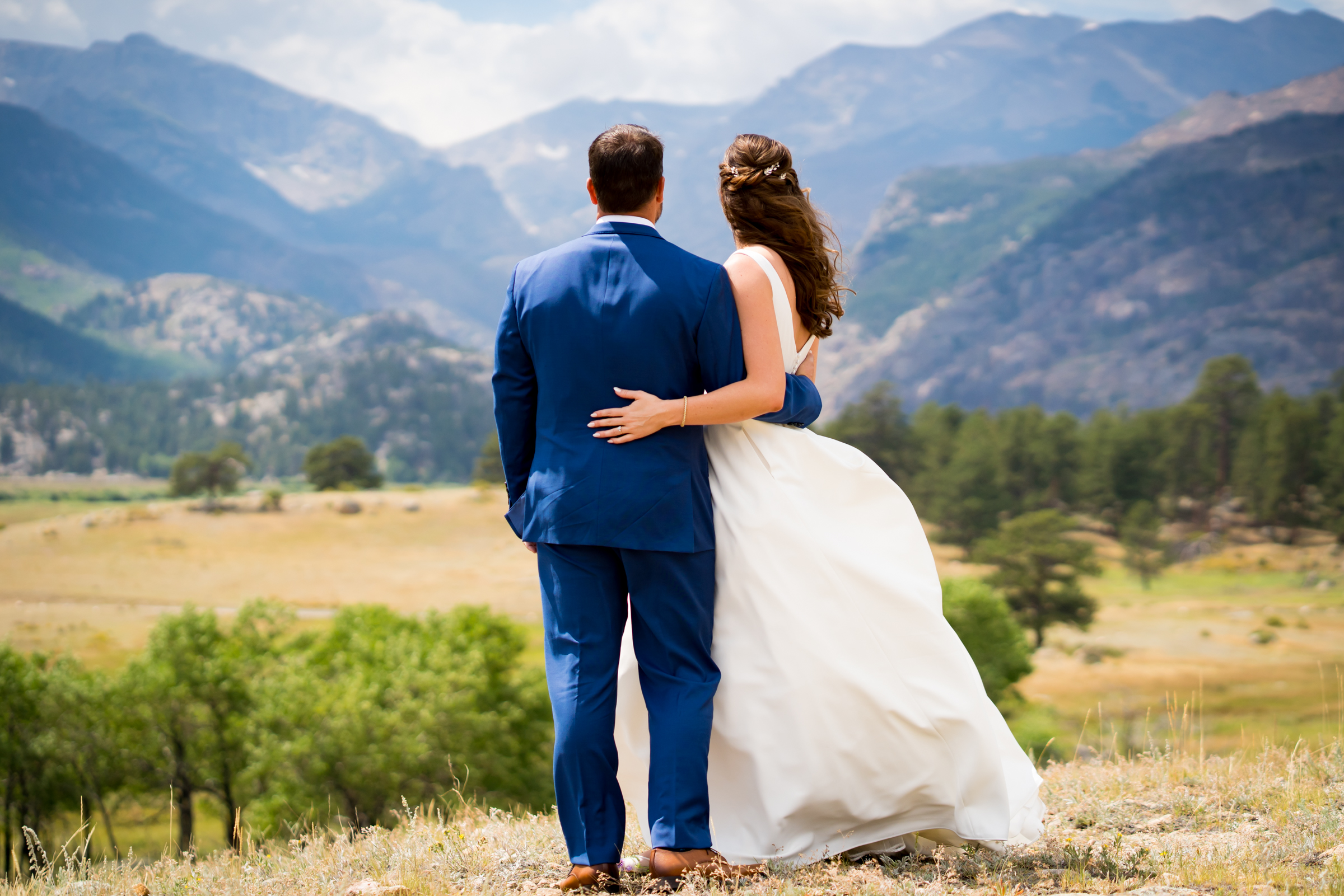 Bride and grooms share first look at Rocky Mountain National Park with the mountains and meadows in the distance