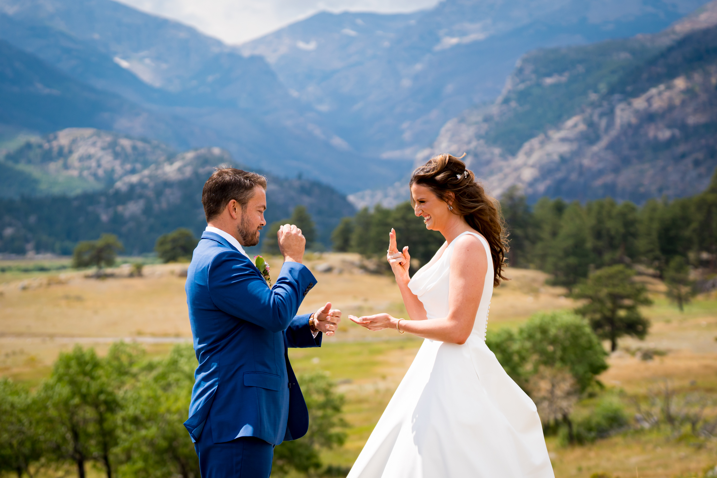 Bride and grooms share first look at Rocky Mountain National Park with the mountains and meadows in the distance