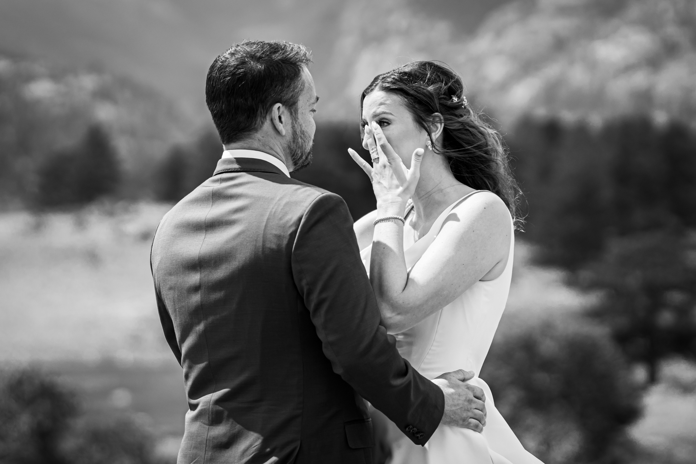 Bride and grooms share first look at Rocky Mountain National Park with the mountains and meadows in the distance