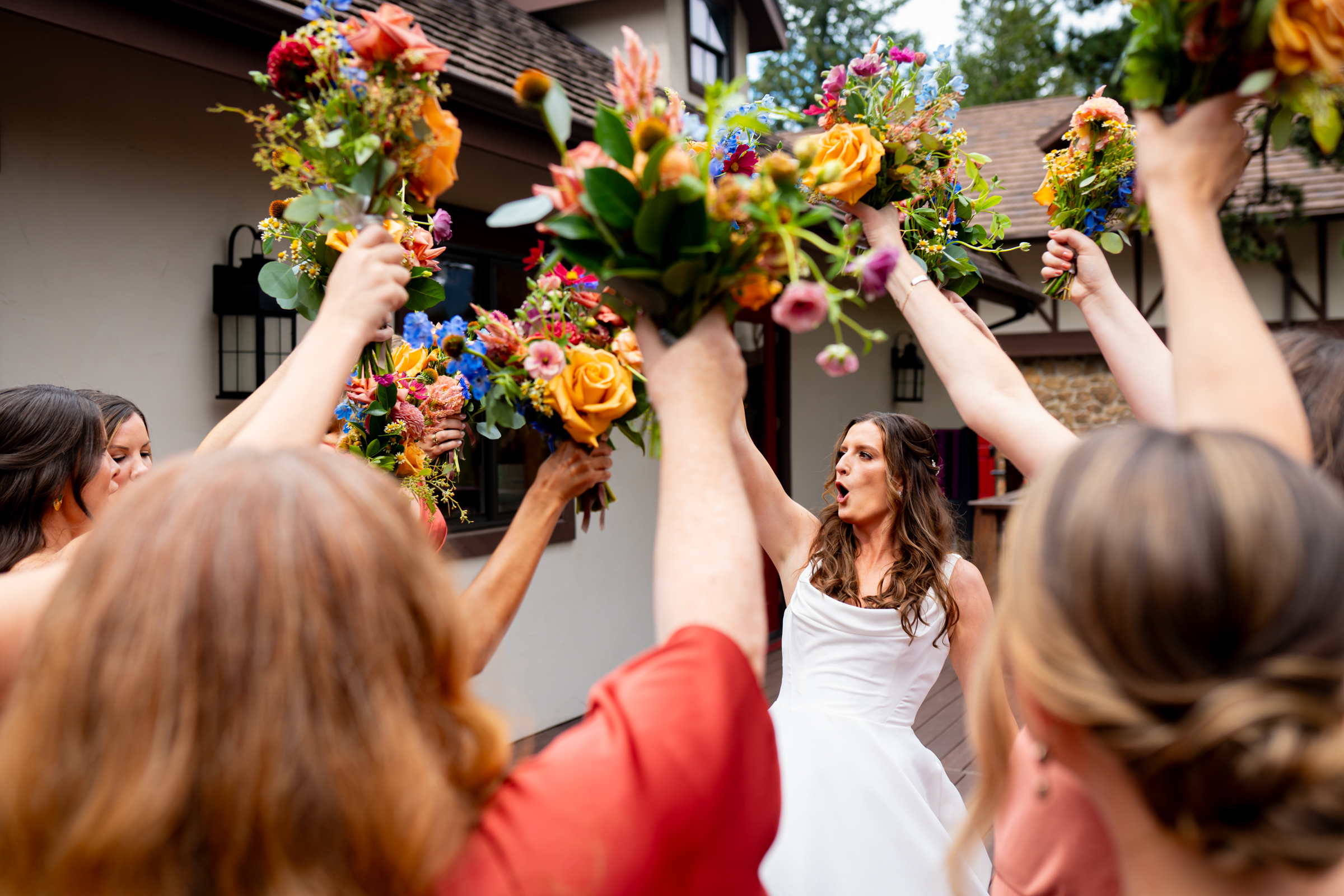 Bride has a first look with her bridesmaids on a balcony before the wedding ceremony