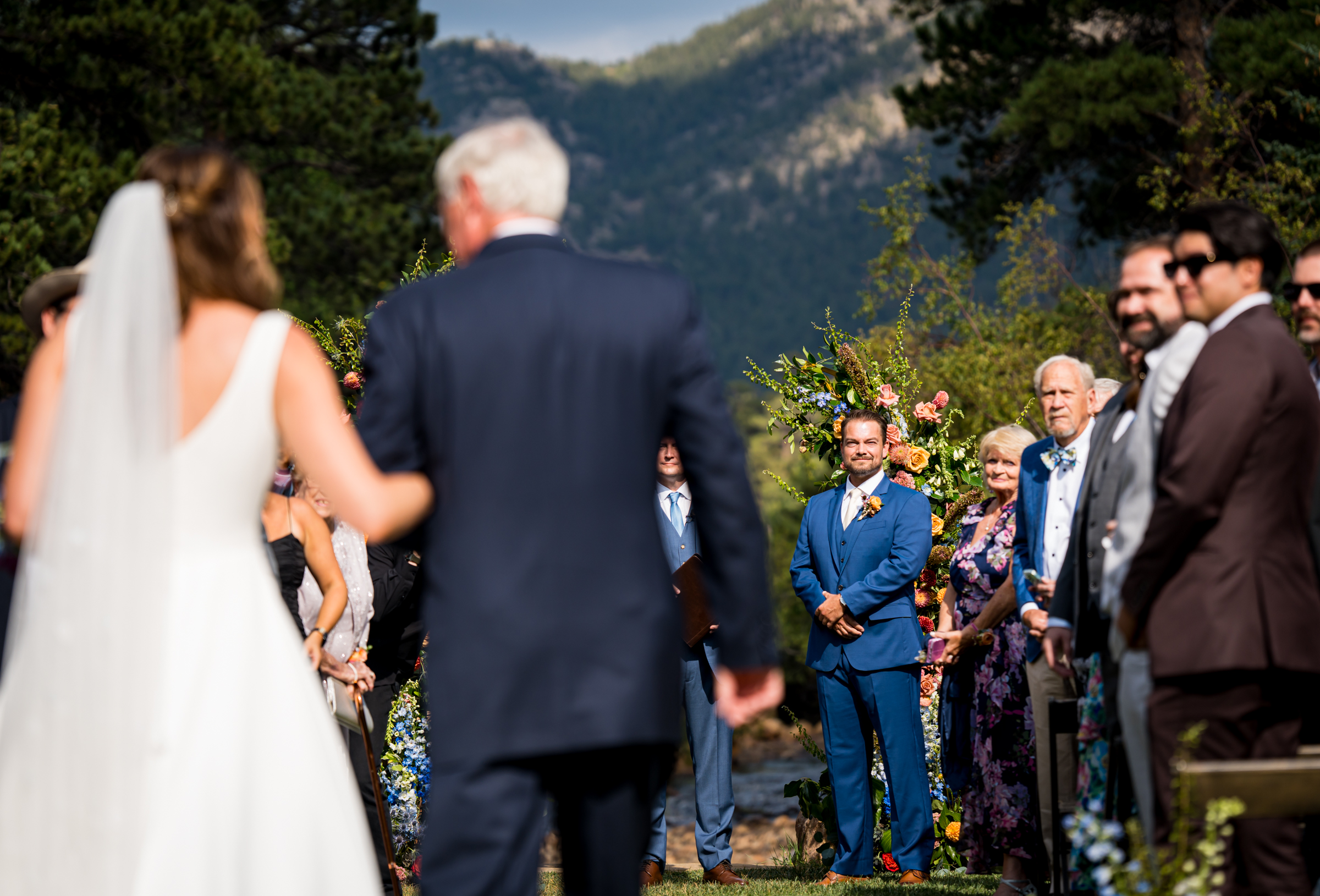 Groom waits as his bride walks down the aisle during the processional