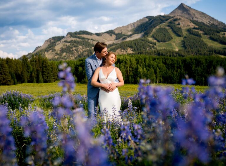 Crested Butte Mountain resort wedding in a field of wildflowers with mount crested butte in the background